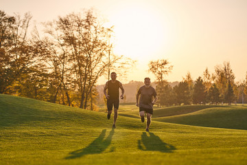 The father and son running in the beautiful park