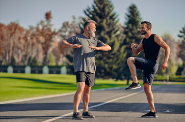 The young and old athletes doing exercise