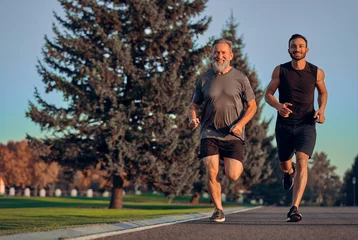 Foto op Aluminium The happy father and son running on the road © realstock1
