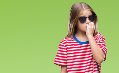 Fototapeta premium Young beautiful girl wearing sunglasses over isolated background looking stressed and nervous with hands on mouth biting nails. Anxiety problem.