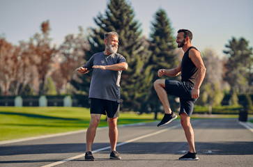 The young and old athletes doing exercise