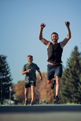The two sportsmen running marathon in the beautiful park