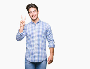 Naklejka premium Young handsome business man over isolated background showing and pointing up with fingers number two while smiling confident and happy.