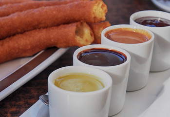 Typical Spanish snack churros are deep-fried pastries and served with hot chocolate everywhere in Spain. Churros con chocolate is a classic Spanish breakfast