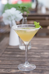  A cocktail  of Tequila, lime, mint leaves, and passionfruit