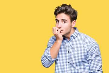 Young handsome business man over isolated background looking stressed and nervous with hands on mouth biting nails. Anxiety problem.