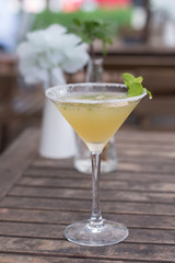  A cocktail  of Tequila, lime, mint leaves, and passionfruit