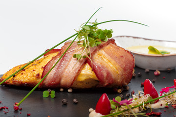 Chicken fillet with grilled bacon isolated on white
