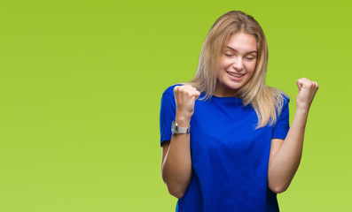 Young caucasian woman over isolated background very happy and excited doing winner gesture with arms raised, smiling and screaming for success. Celebration concept.