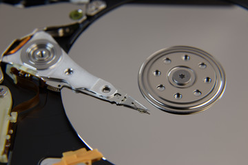 Hard drive from computer or laptop lies on the table in the repair shop. Performs fault diagnostics and performs urgent repairs recovery of lost data during deletion HDD closeup