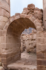 The remains of the arched passage between the halls in remains of Roman Temple in Petra. Near Wadi Musa city in Jordan