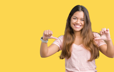 Young beautiful brunette woman wearing pink t-shirt over isolated background looking confident with...