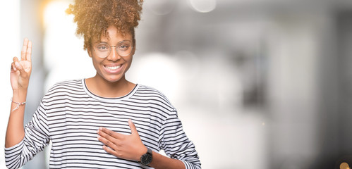 Beautiful young african american woman wearing glasses over isolated background Swearing with hand...