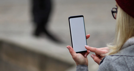 businesswoman typing text message on her cellphone