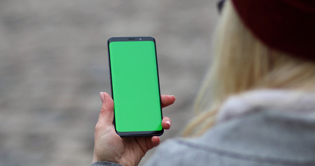 businesswoman typing text message on her cellphone