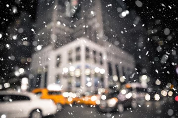 Keuken spatwand met foto Defocused blur New York City midtown Manhattan street scene with yellow taxi cab and snowflakes falling during winter snow storm © littleny