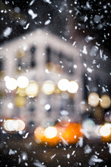 Defocused blur New York City midtown Manhattan street scene with yellow taxi cab and snowflakes...