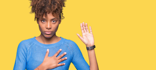 Beautiful young african american woman over isolated background Swearing with hand on chest and open palm, making a loyalty promise oath - obrazy, fototapety, plakaty