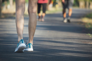 The female walking at the morning for warm up body for jogging and exercise.