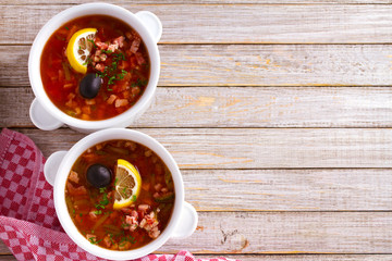 Russian dish  solyanka - thick, spicy and sour saltwort soup. overhead, horizontal