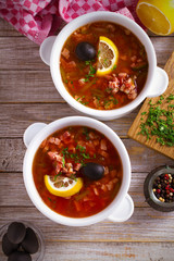 Russian dish  solyanka - thick, spicy and sour saltwort soup. overhead, vertical