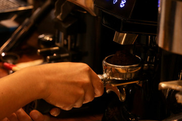 Process pressing ground coffee with tamper