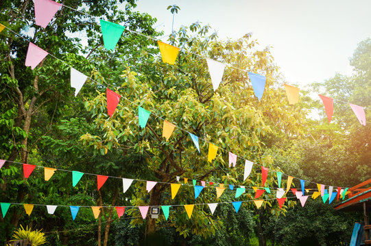 Colorful party flags made of paper / Triangle paper flag hang in the garden decorate in event