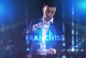 The concept of business, technology, the Internet and the network. A young entrepreneur working on a virtual screen of the future and sees the inscription: Franchise