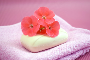 Obraz na płótnie Canvas Fragrant flower soap on a pink towel.