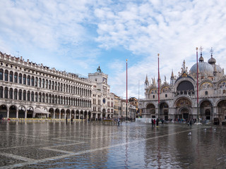 Obraz premium VENICE, ITALY, NOV 1st 2018: Saint Mark's or San Marco Square and Cathedral or Palace Domes. Ancient renaissance italian or venetian architecture exterior view. Vivid color. Flood time. People