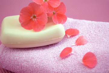 Obraz na płótnie Canvas Fragrant flower soap on a pink towel.
