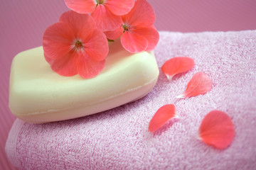 Fragrant flower soap on a pink towel.