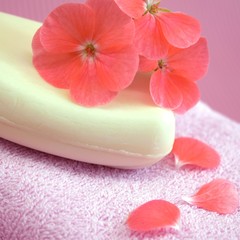 Obraz na płótnie Canvas Fragrant flower soap on a pink towel.