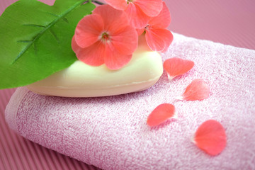 Fragrant flower soap on a pink towel.