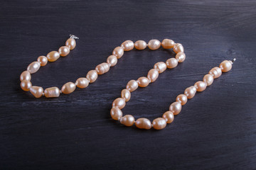 caramel colored pearl beads on a black background