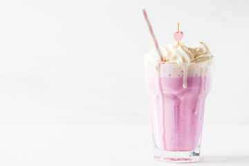 Strawberry milkshake with whipped cream on white background, copy space for text. Valentine's day...