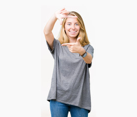 Beautiful young woman wearing oversize casual t-shirt over isolated background smiling making frame with hands and fingers with happy face. Creativity and photography concept.