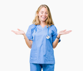 Beautiful young doctor woman wearing medical uniform over isolated background Smiling showing both...