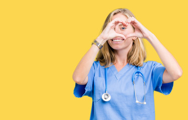 Beautiful young doctor woman wearing medical uniform over isolated background Doing heart shape...