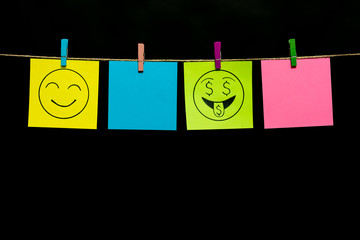 Copy space. Four stickers. On one yellow page smiley with an expression of love for money, on other of smile.
