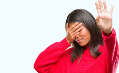 Young asian woman wearing winter sweater over isolated background covering eyes with hands and doing stop gesture with sad and fear expression. Embarrassed and negative concept.