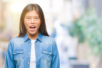 Fototapeta premium Young asian woman over isolated background afraid and shocked with surprise expression, fear and excited face.
