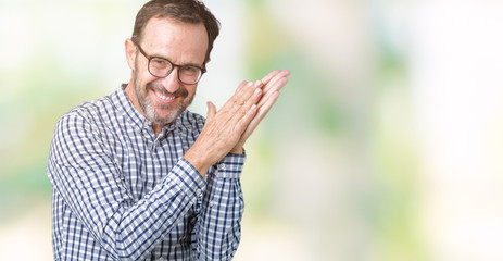 Handsome middle age elegant senior man wearing glasses over isolated background Clapping and applauding happy and joyful, smiling proud hands together
