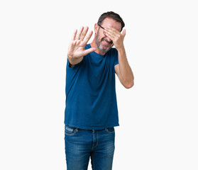 Fototapeta premium Handsome middle age hoary senior man wearin glasses over isolated background covering eyes with hands and doing stop gesture with sad and fear expression. Embarrassed and negative concept.