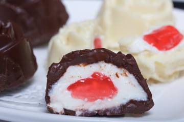 Homemade cheese curds. Some are cut in two, jelly filling is visible.