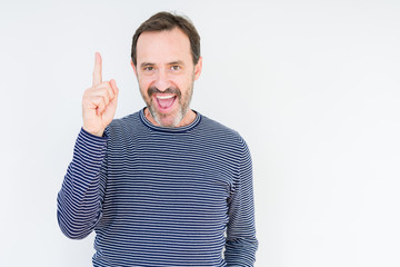 Fototapeta premium Handsome senior man over isolated background pointing finger up with successful idea. Exited and happy. Number one.