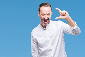 Fototapeta premium Middle age hoary senior man over isolated background smiling and confident gesturing with hand doing size sign with fingers while looking and the camera. Measure concept.
