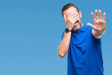 Fototapeta premium Middle age hoary senior man over isolated background covering eyes with hands and doing stop gesture with sad and fear expression. Embarrassed and negative concept.