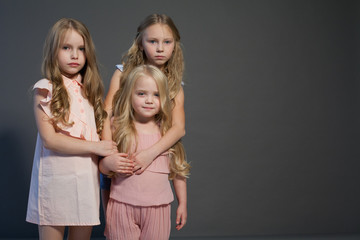 three little girls blonde girlfriends sisters portrait