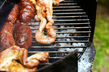 Closeup of sausages cooking on a barbecue grill Argentina